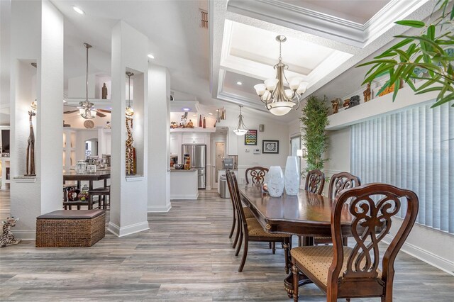 dining room with hardwood / wood-style flooring and crown molding