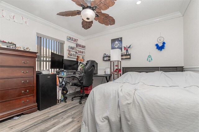 bedroom with ceiling fan, light wood-type flooring, and crown molding