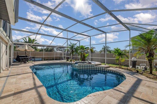 view of swimming pool with a lanai, an in ground hot tub, and a patio