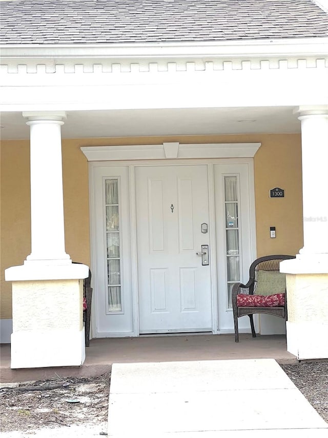 view of exterior entry with covered porch