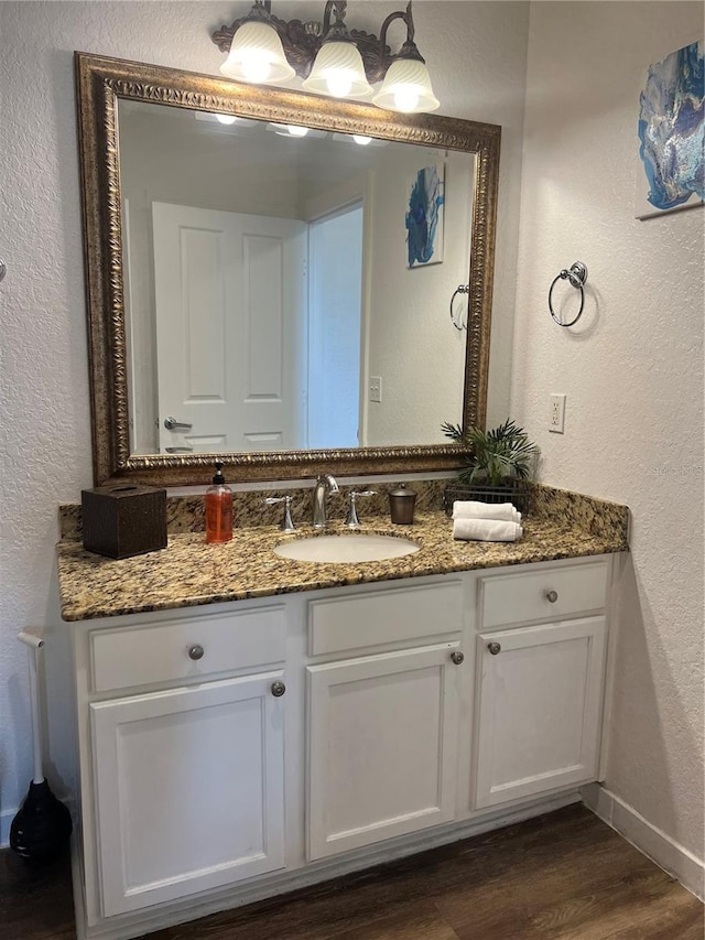 bathroom with hardwood / wood-style floors and vanity