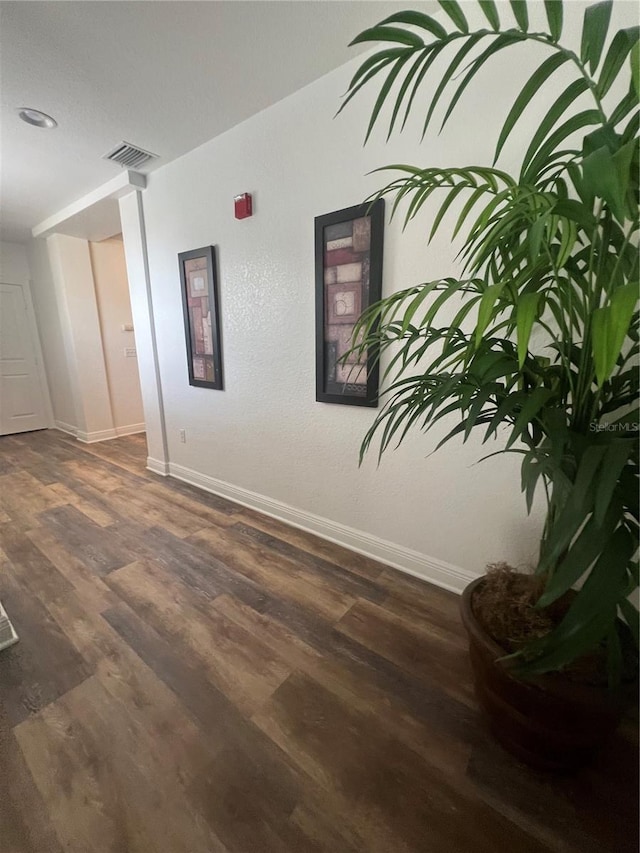 unfurnished room with dark hardwood / wood-style flooring