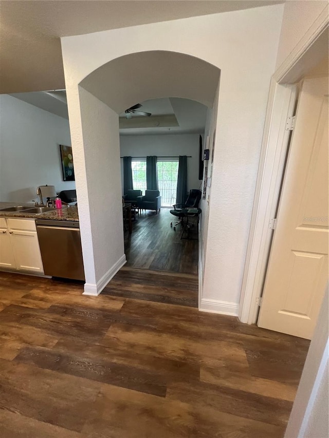 corridor with dark hardwood / wood-style floors and sink