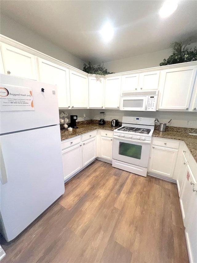 kitchen featuring white appliances, light hardwood / wood-style floors, and white cabinetry