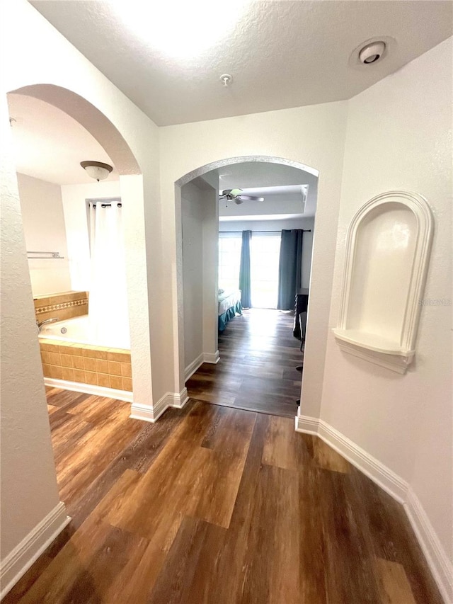 corridor featuring dark wood-type flooring