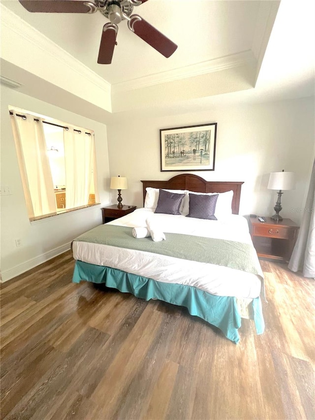 bedroom featuring wood-type flooring, ornamental molding, and ceiling fan