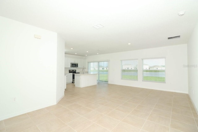 unfurnished living room with light tile patterned floors