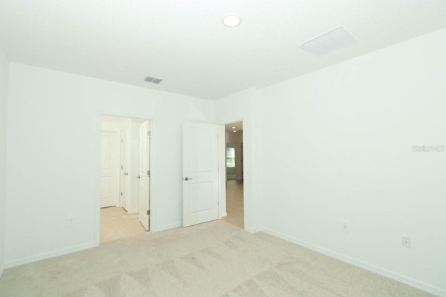 empty room featuring light colored carpet