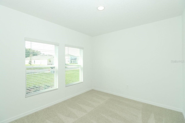 spare room with light colored carpet