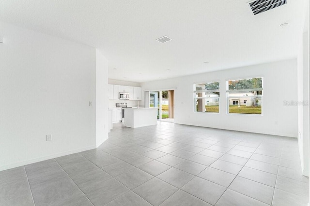 unfurnished living room with light tile patterned floors