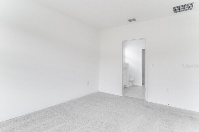 empty room featuring light colored carpet