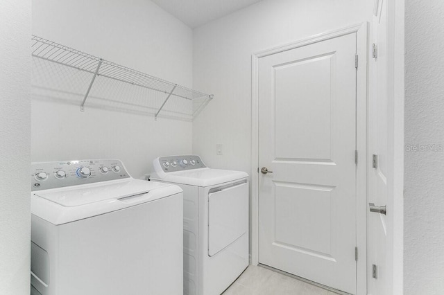 clothes washing area featuring washing machine and clothes dryer