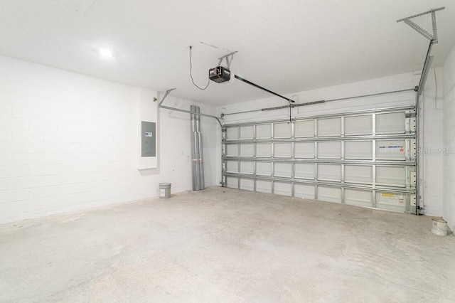 garage with a garage door opener and electric panel