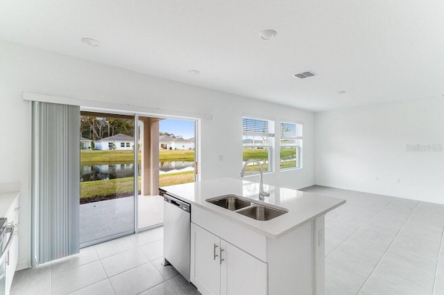 kitchen featuring sink, a water view, an island with sink, white cabinets, and stainless steel dishwasher