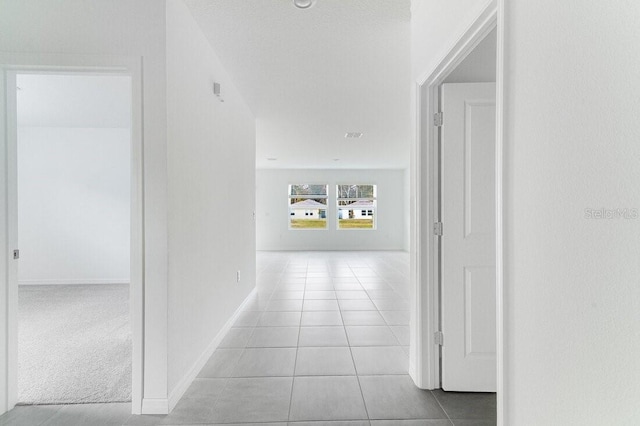 hallway featuring light tile patterned flooring