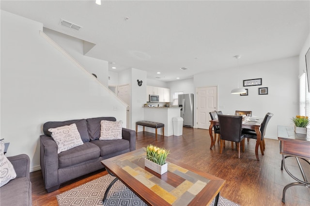 living room featuring dark wood-type flooring