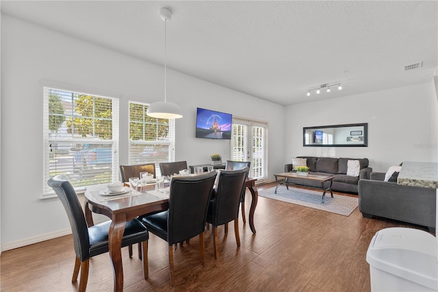 dining area featuring a wealth of natural light and hardwood / wood-style floors