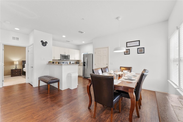 dining area with dark wood-type flooring