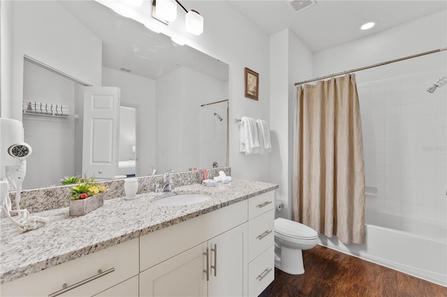 full bathroom featuring shower / tub combo, hardwood / wood-style flooring, vanity, and toilet