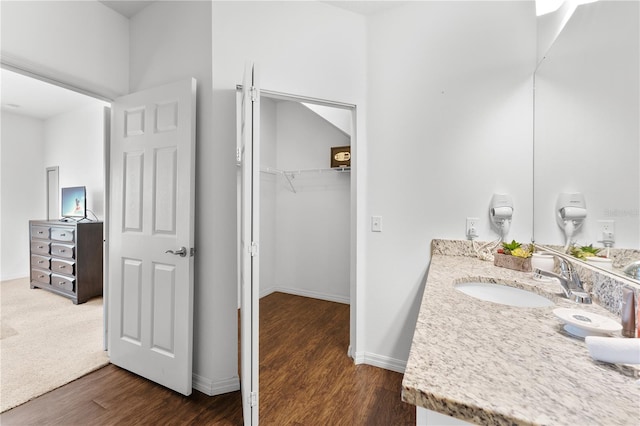 bathroom with hardwood / wood-style floors and vanity