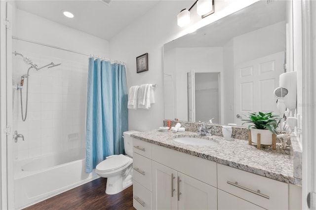 full bathroom with vanity, shower / tub combo, toilet, and hardwood / wood-style flooring