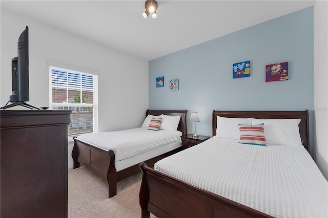 bedroom featuring light carpet