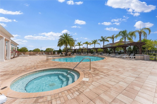 view of pool with a community hot tub and a patio area