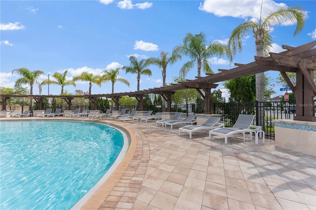 view of swimming pool featuring a pergola and a patio