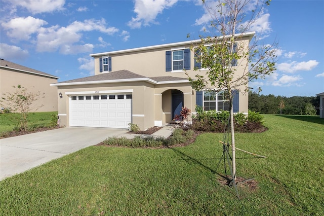 view of front of home featuring a front yard and a garage