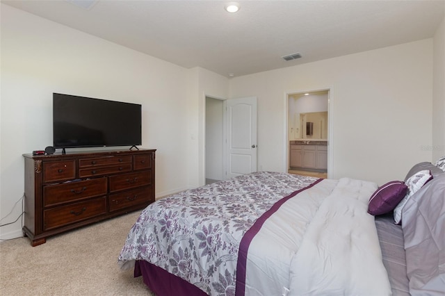 carpeted bedroom with ensuite bathroom