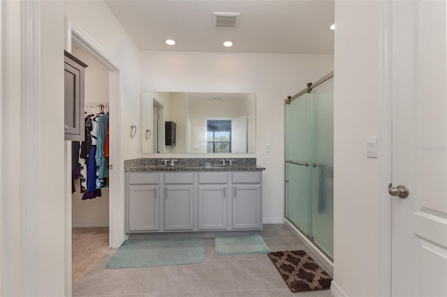 bathroom with vanity, tile patterned flooring, and an enclosed shower