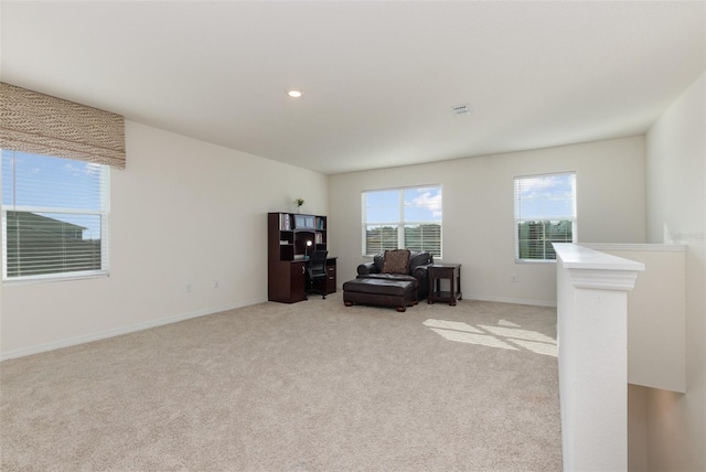 living area with light carpet