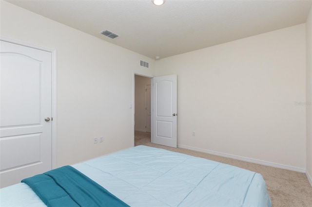 bedroom featuring light colored carpet