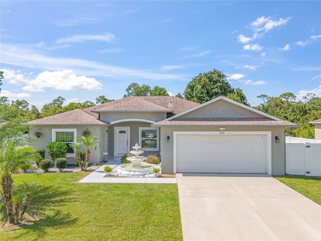 view of front facade featuring a front yard and a garage