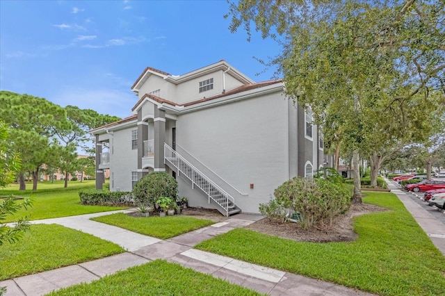 view of side of property with a lawn