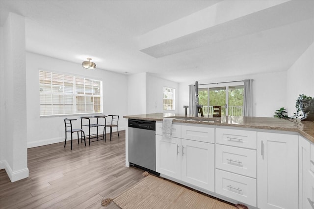 kitchen featuring light wood-type flooring, sink, dishwasher, light stone countertops, and white cabinets