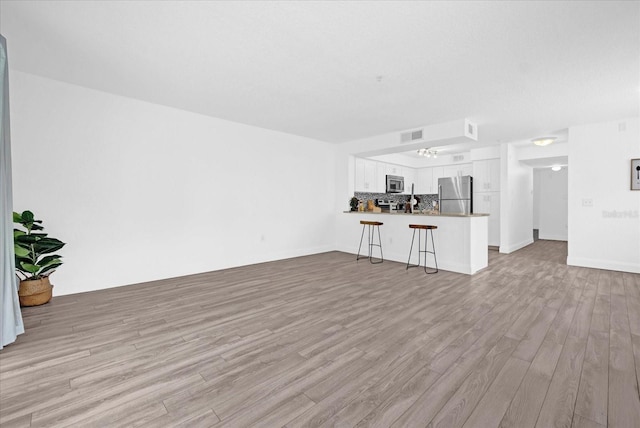 unfurnished living room featuring light hardwood / wood-style floors