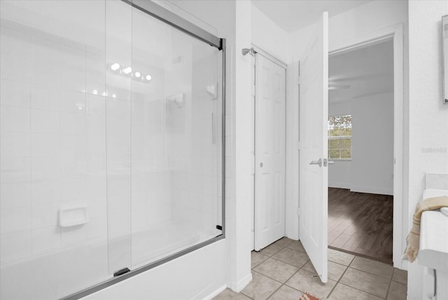 bathroom with wood-type flooring and a shower with door