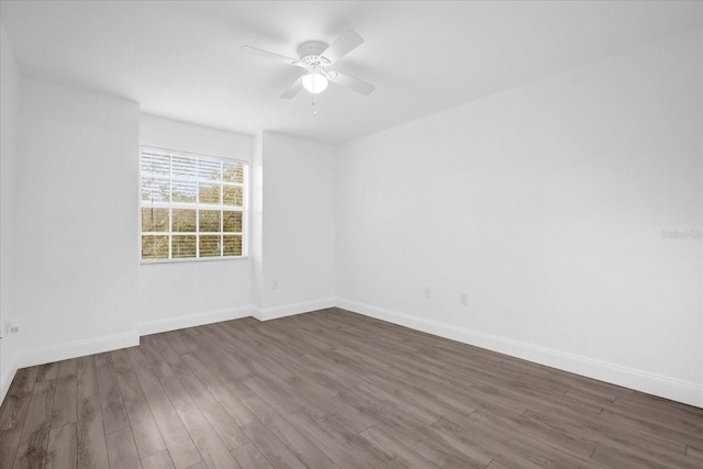 unfurnished room featuring ceiling fan and dark hardwood / wood-style flooring