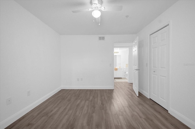 interior space featuring ceiling fan, a closet, and dark wood-type flooring