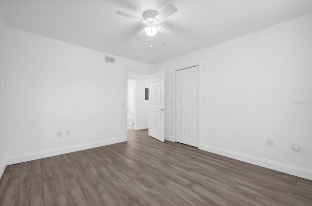 unfurnished bedroom with dark hardwood / wood-style flooring and ceiling fan