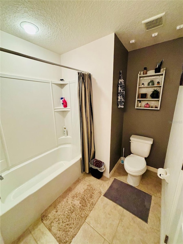 bathroom with shower / bath combo with shower curtain, tile patterned floors, a textured ceiling, and toilet