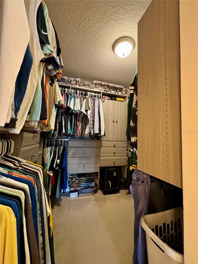 walk in closet with carpet