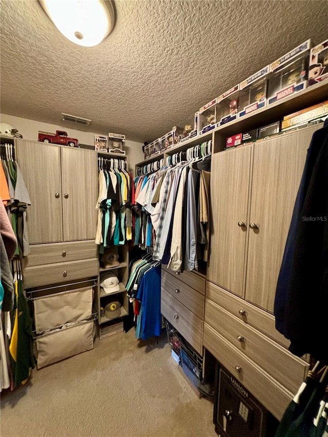 walk in closet featuring carpet flooring