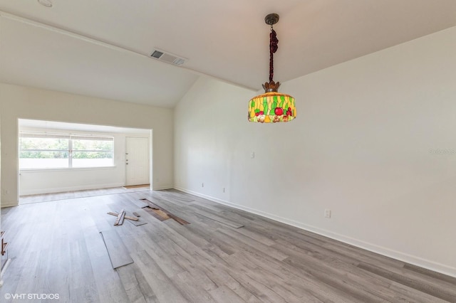 unfurnished room with lofted ceiling and light hardwood / wood-style flooring