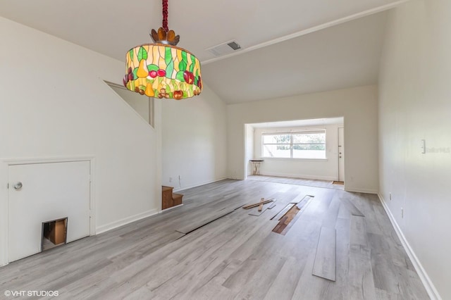 unfurnished living room featuring lofted ceiling and light hardwood / wood-style flooring