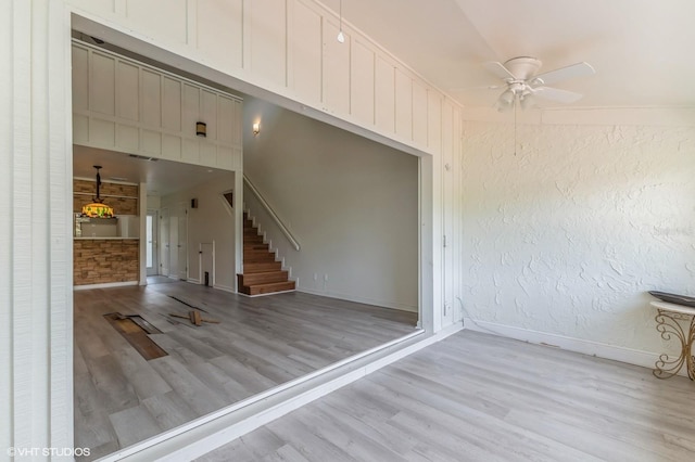 interior space featuring ceiling fan, lofted ceiling, and light hardwood / wood-style flooring