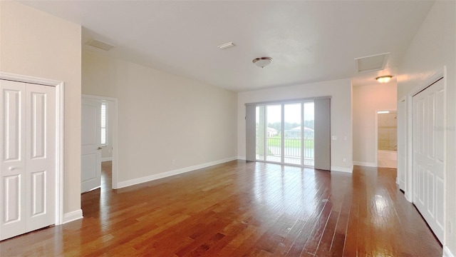 spare room featuring dark hardwood / wood-style floors