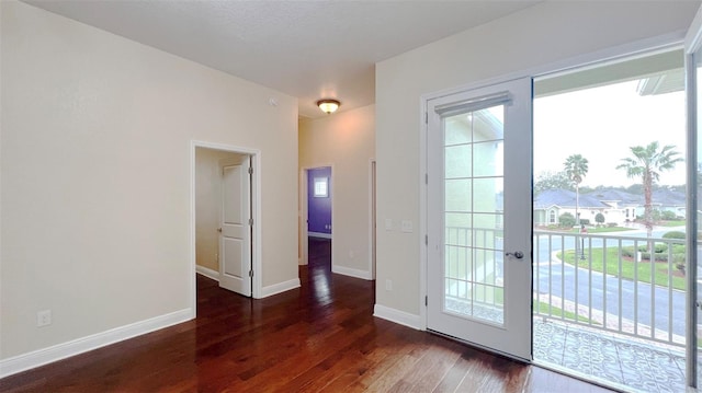 doorway with dark hardwood / wood-style floors, a textured ceiling, and french doors