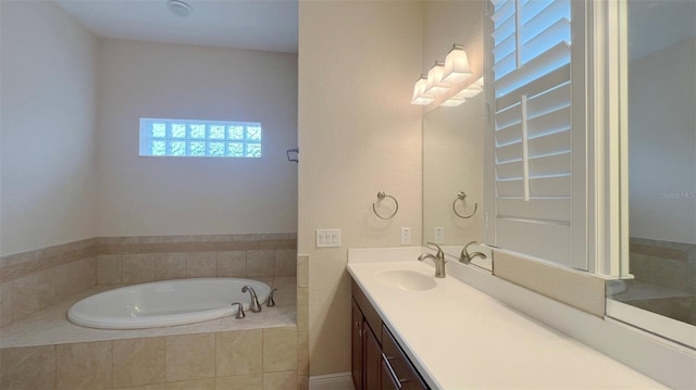 bathroom with tiled bath and vanity